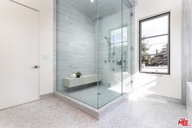 bathroom featuring tile patterned floors and a shower with shower door