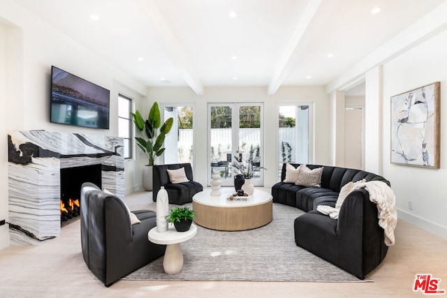 living room with beamed ceiling and light wood-type flooring