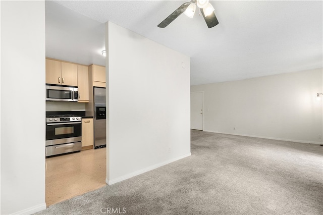 kitchen featuring ceiling fan, light brown cabinetry, a textured ceiling, and appliances with stainless steel finishes