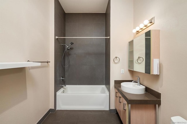 bathroom with tiled shower / bath, tile patterned floors, and vanity