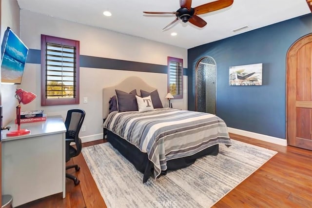 bedroom featuring hardwood / wood-style flooring and ceiling fan