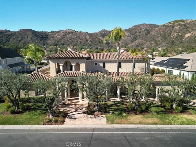 mediterranean / spanish-style house featuring a mountain view and a balcony