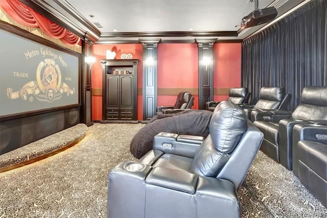 carpeted cinema room featuring ornate columns and crown molding