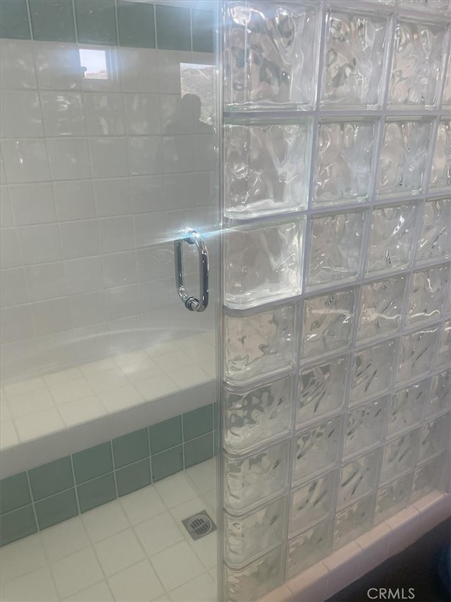 bathroom featuring tile patterned flooring and a shower with door