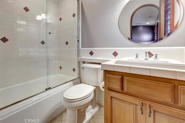 full bathroom with tile patterned flooring, vanity, toilet, and shower / bath combination with glass door