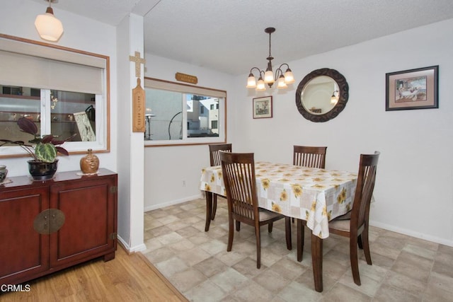 dining space with a notable chandelier and light wood-type flooring