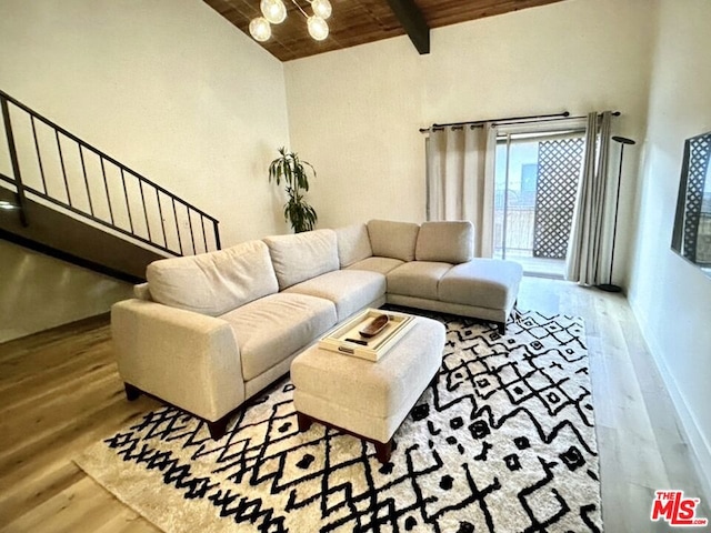 living room with light hardwood / wood-style flooring, beamed ceiling, wooden ceiling, and high vaulted ceiling