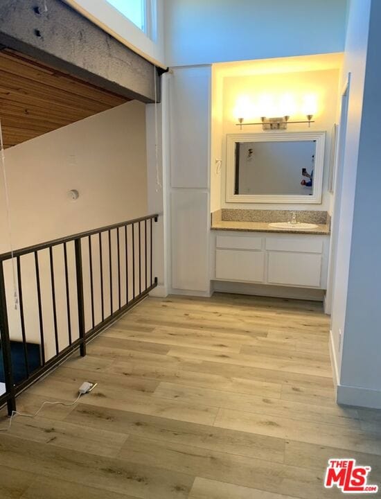 hallway featuring light wood-type flooring and sink