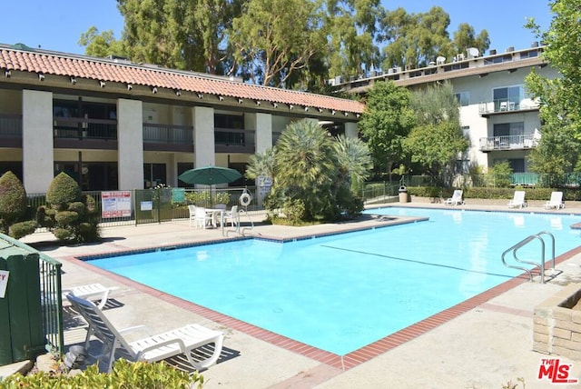 view of swimming pool featuring a patio area