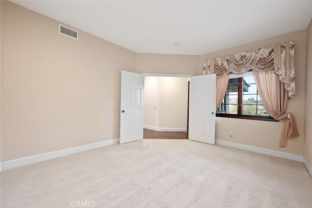 unfurnished bedroom with light colored carpet