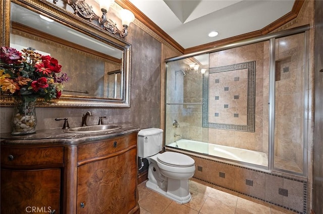 full bathroom with tile patterned flooring, toilet, shower / bath combination with glass door, vanity, and ornamental molding