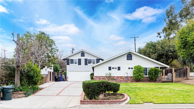 view of property featuring a garage and a front lawn