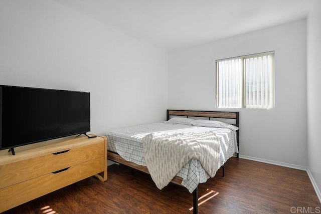 bedroom with dark wood-type flooring