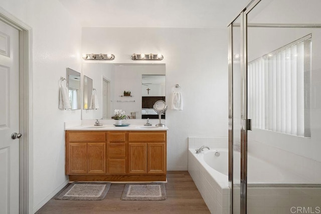 bathroom with hardwood / wood-style flooring, vanity, and independent shower and bath