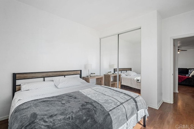 bedroom featuring dark hardwood / wood-style flooring and a closet