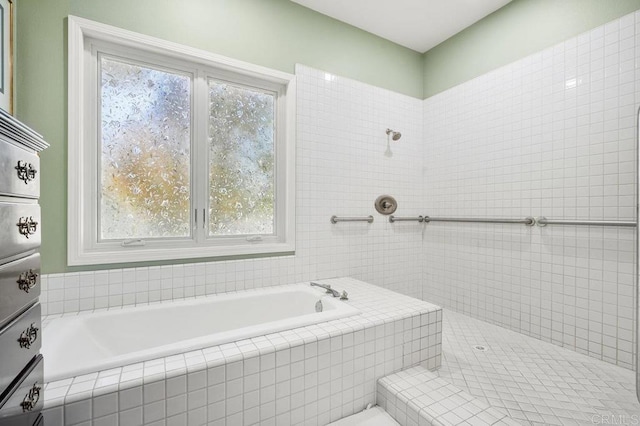 bathroom featuring tiled bath