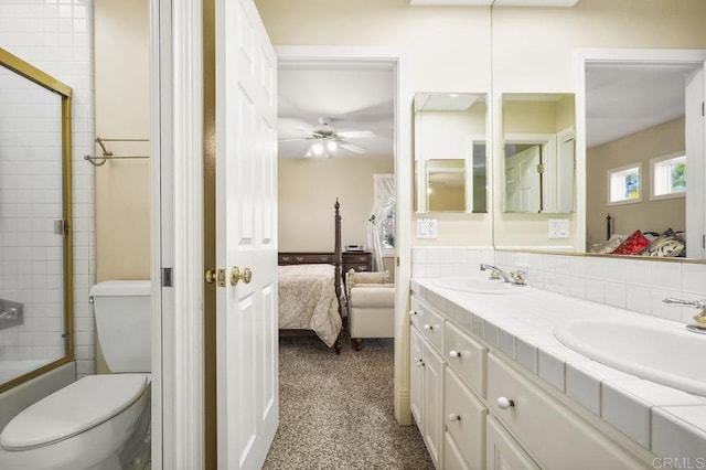 full bathroom with ceiling fan, toilet, bath / shower combo with glass door, and vanity