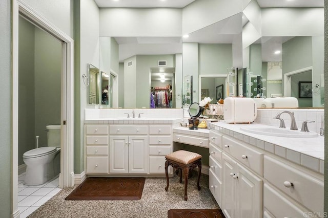 bathroom featuring tile patterned flooring, vanity, and toilet