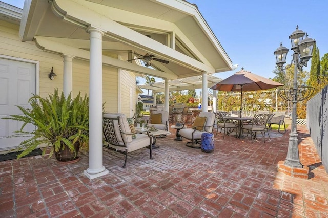 view of patio / terrace featuring ceiling fan and exterior kitchen