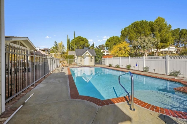 view of swimming pool with an outdoor structure and a patio area