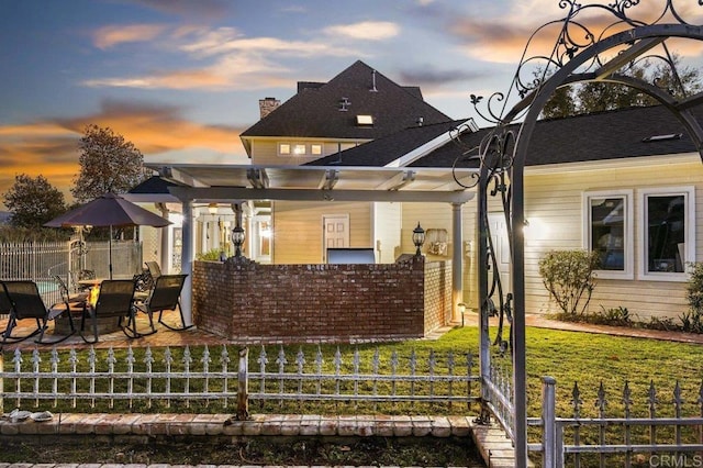 back house at dusk with a yard