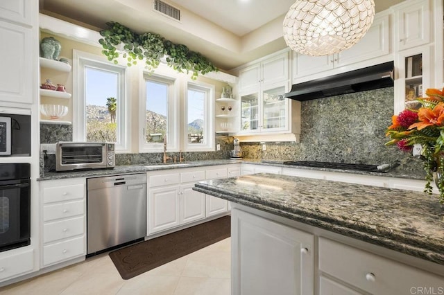 kitchen featuring light tile patterned floors, white cabinetry, dark stone counters, and black appliances