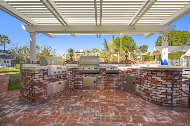 view of patio / terrace featuring an outdoor kitchen, a pergola, and grilling area