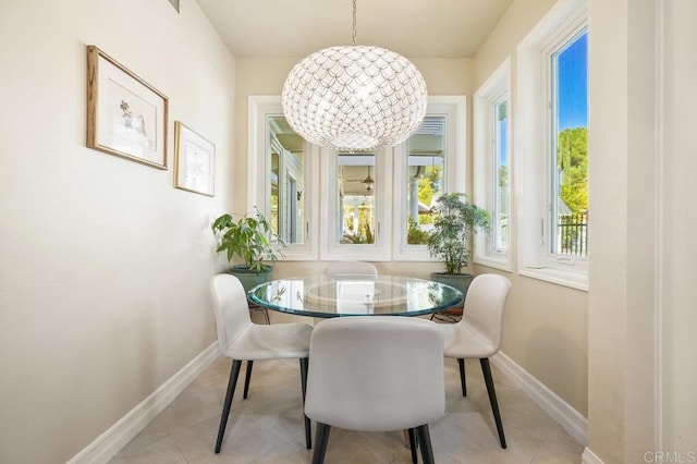 tiled dining space featuring a wealth of natural light and an inviting chandelier