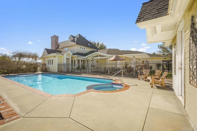 view of pool featuring an in ground hot tub and a patio