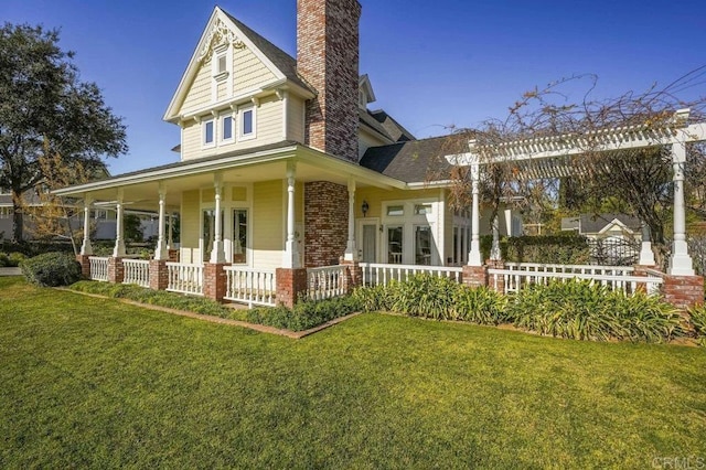 view of front of house with a front lawn and covered porch