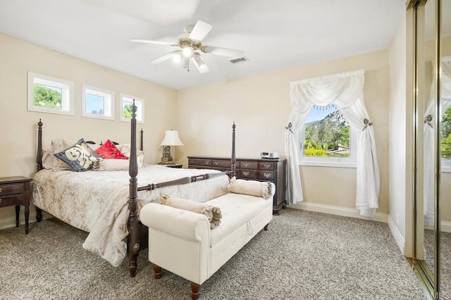 bedroom featuring carpet, multiple windows, and ceiling fan