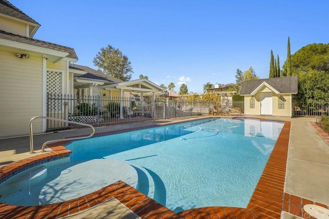 view of swimming pool with an outdoor structure