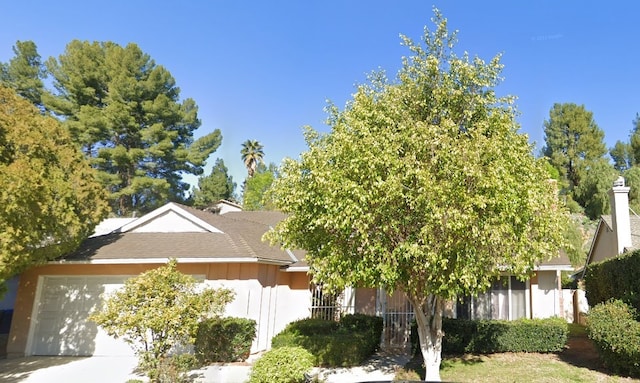 obstructed view of property with a garage