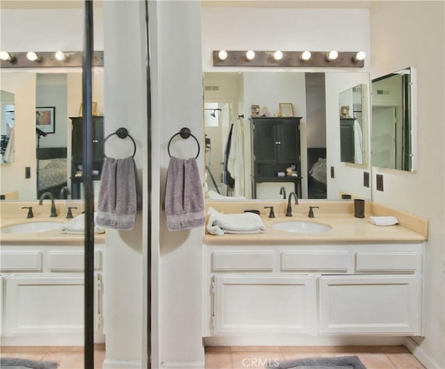 bathroom with tile patterned flooring and vanity