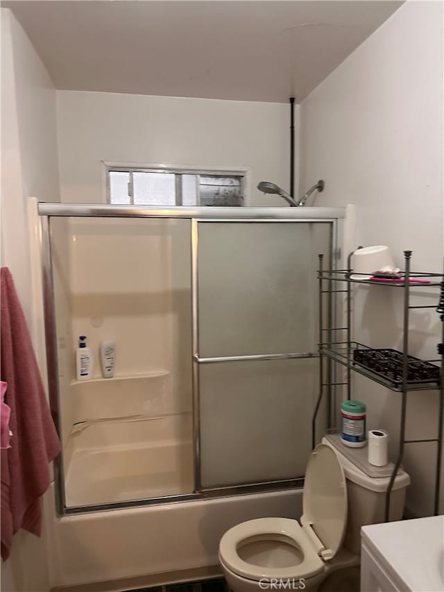 full bathroom featuring shower / bath combination with glass door, vanity, and toilet