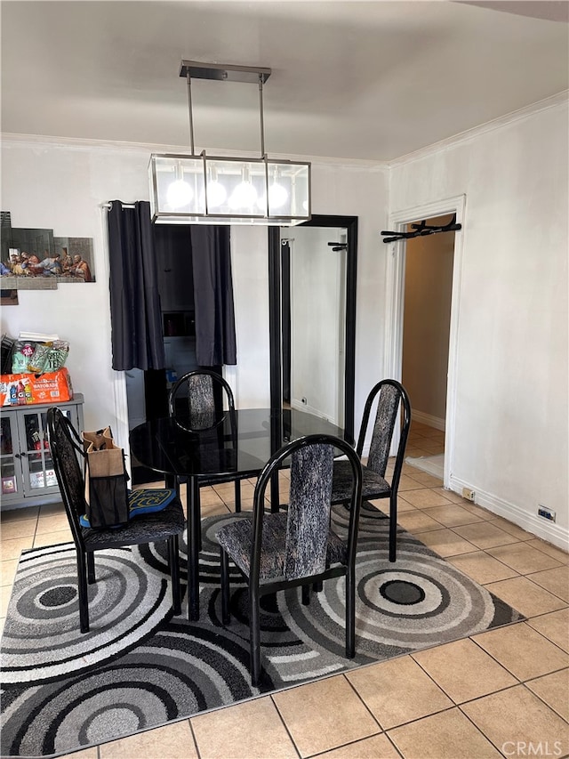 dining space featuring light tile patterned floors and ornamental molding