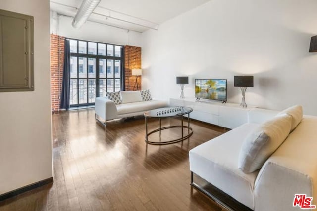 living room with wood-type flooring and electric panel