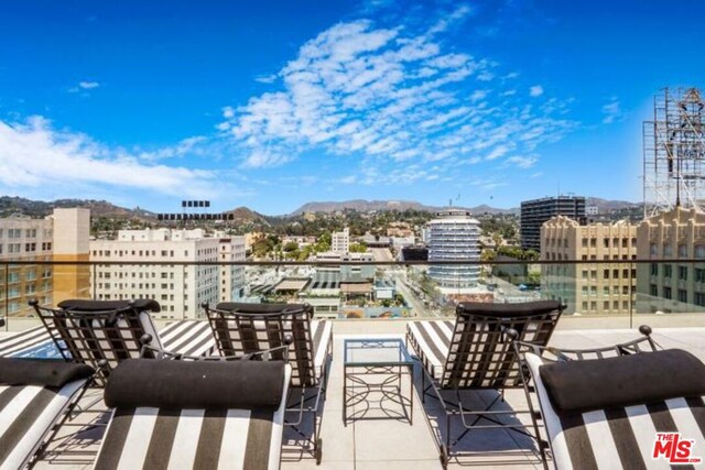 view of patio / terrace featuring a mountain view and a balcony