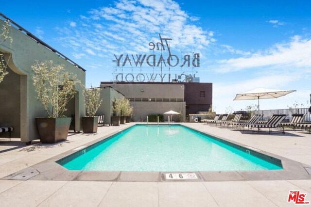 view of swimming pool featuring a patio area