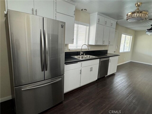 kitchen with white cabinets, stainless steel appliances, dark hardwood / wood-style floors, and sink