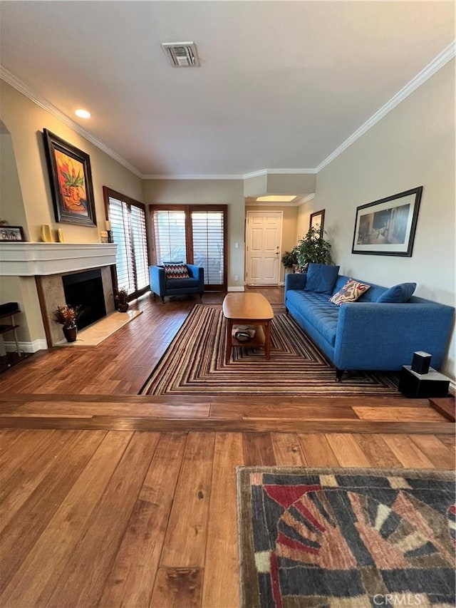 living room with hardwood / wood-style flooring and crown molding