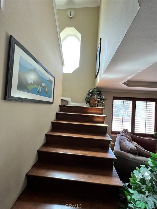 stairs featuring crown molding