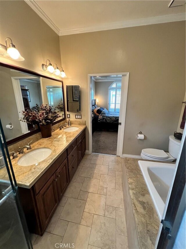 bathroom featuring toilet, ornamental molding, a tub to relax in, and vanity