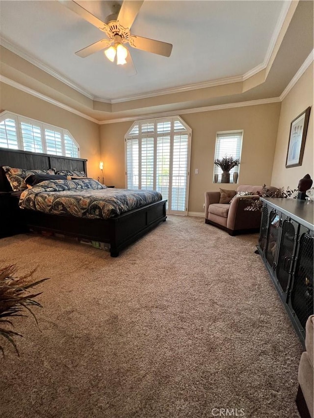 bedroom with ceiling fan, carpet floors, access to outside, a tray ceiling, and ornamental molding