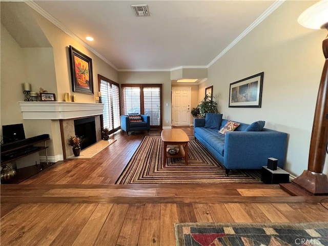 living room with crown molding and hardwood / wood-style flooring