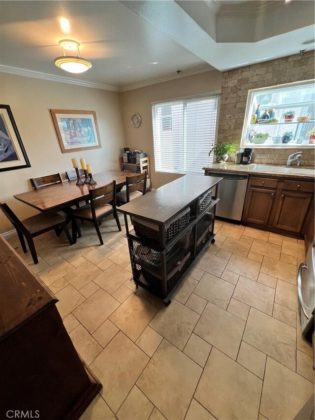 kitchen featuring stainless steel dishwasher, sink, and ornamental molding