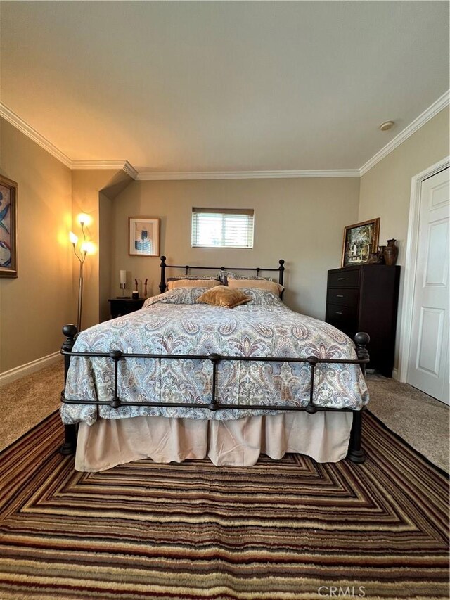 bedroom with carpet flooring and crown molding