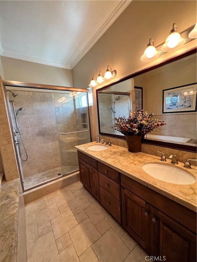 bathroom featuring a shower with shower door, vanity, and ornamental molding