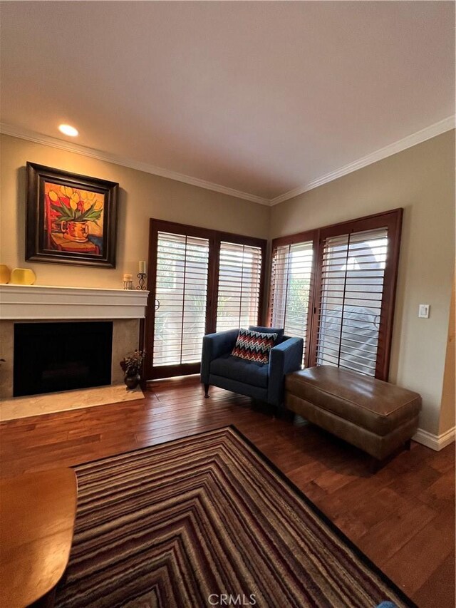 unfurnished living room featuring plenty of natural light, crown molding, and hardwood / wood-style flooring