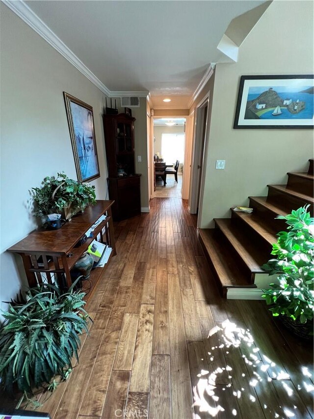 hall with crown molding and hardwood / wood-style floors